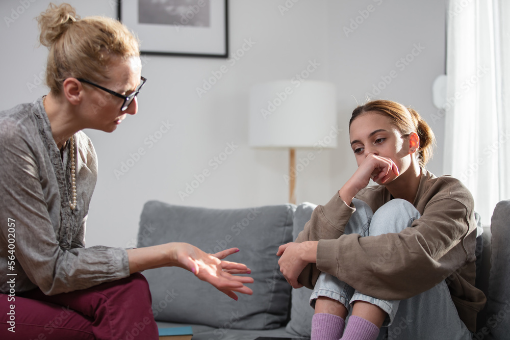 Mother talking with difficult teenager daughter at home. Mother talking with difficult teenager daughter at home.