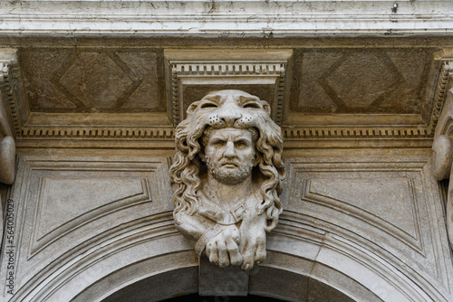 Close-up of a sculpture depicting Hercules with the skin of the Nemean lion above the front door of an ancient palace in Campo San Polo, Venice, Veneto, Italy