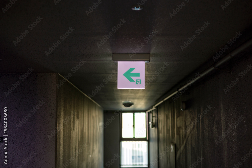 Emergency exit sign at the hallway of building