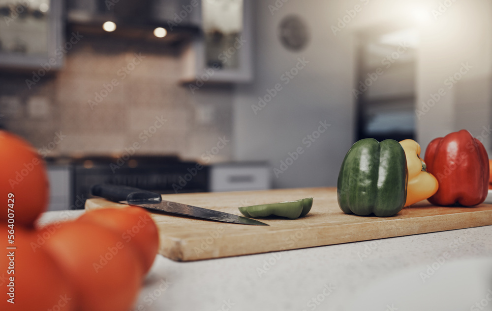 Kitchen, table and cutting board with vegetables of colorful peppers for healthy meal preparation at home. Food, cooking or nutrition of organic grown consumables on counter for diet plan or vitamins Kitchen, table and cutting board with vegetables of colorful peppers for healthy meal preparation at home. Food, cooking or nutrition of organic grown consumables on counter for diet plan or vitamins