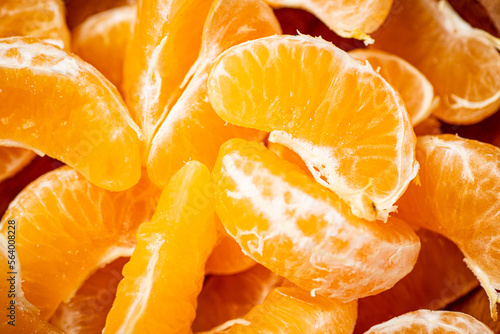 Peeled pieces of ripe tangerines. Macro background.