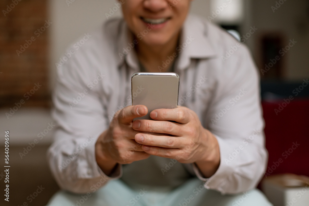 Online shopping. Happy asian man using modern smartphone, purchasing from internet via app on mobile phone, closeup Online shopping. Happy asian man using modern smartphone, purchasing from internet via app on mobile phone, closeup