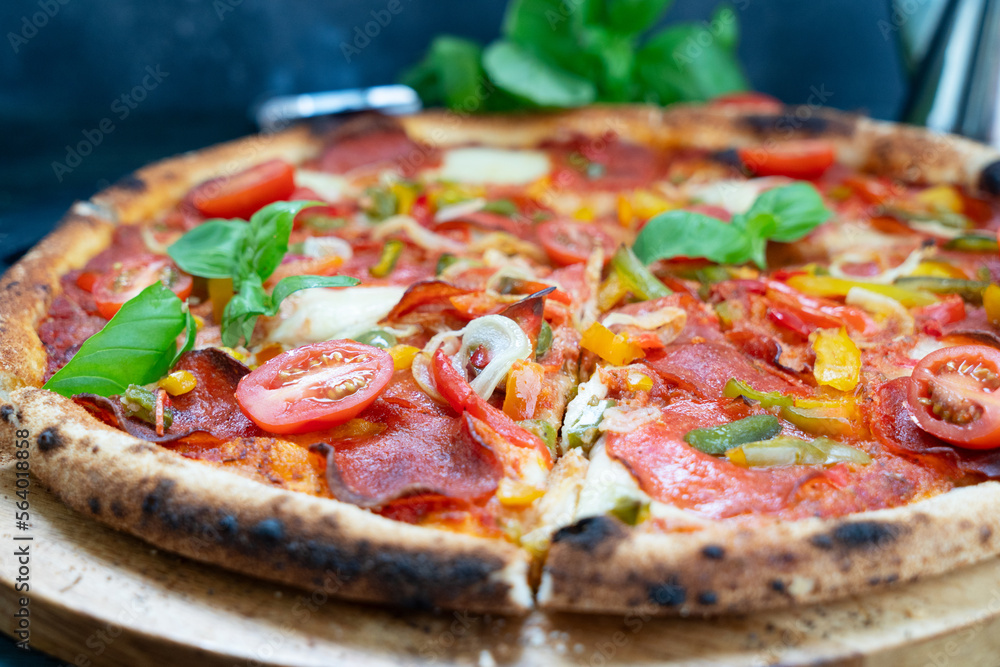 Pizza with salami and tomatoes