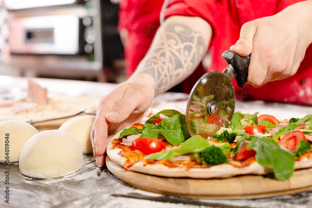 pizzaiolo prepares pizza in the kitchen, the chef prepares the dough