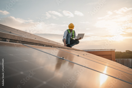 Service engineer checking solar cell on the roof for maintenance if there is a damaged part. Engineer worker install solar panel. Clean energy concept. © NewSaetiew