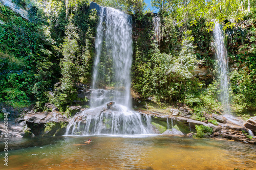 Rosario Waterfall. This waterfall is compared to an oasis of crystalline waters with natural pools  with 13 meter in height and the green fields make this tourist hot spot. Piren  polis. Brazil  2020