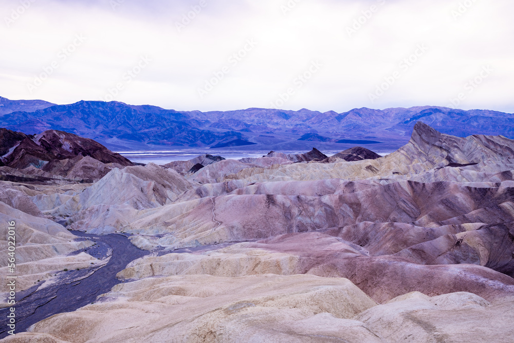 Zabriskie Point. It is a part of the Amargosa Range located east of Death Valley National Park in California, United States. One Man on the Top of Mountain.
