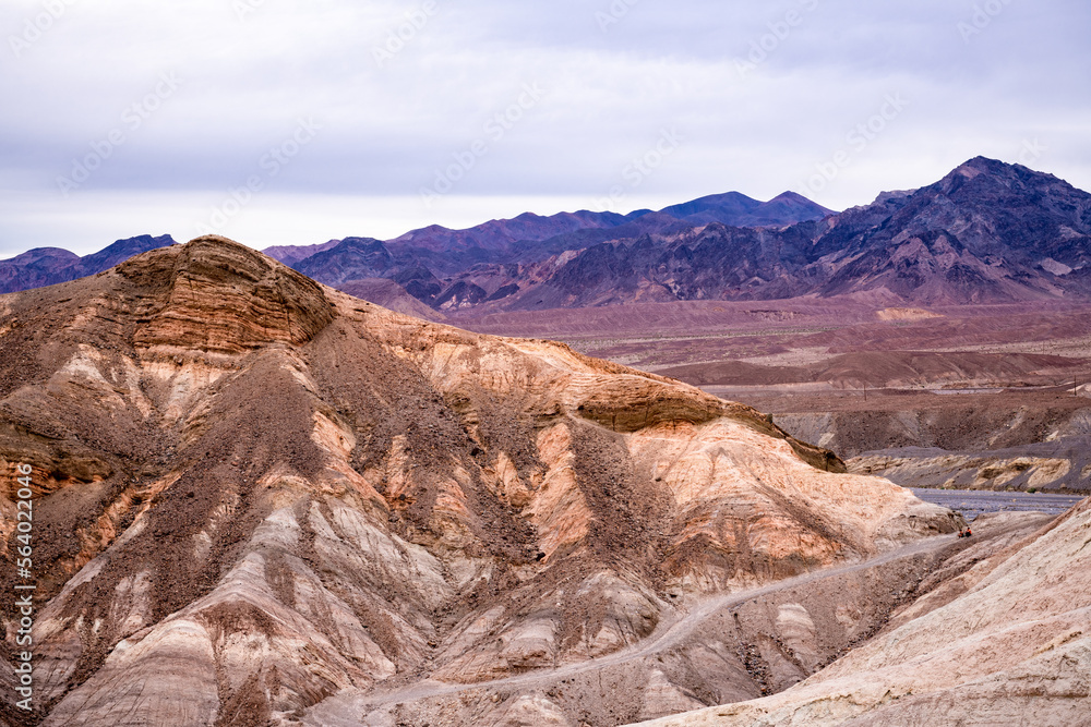 Zabriskie Point. It is a part of the Amargosa Range located east of Death Valley National Park in California, United States. One Man on the Top of Mountain.