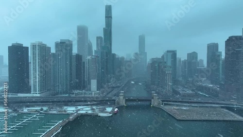 Drone aerial view of Chicago skyline from Lake Michigan flying over Chicago River snowing in winter on cloudy day