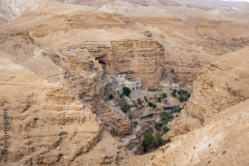 Wadi Qelt in Judean desert around St. George Orthodox Monastery, or Monastery of St. George of Choziba, Israel. The sixth-century cliff-hanging complex. photo