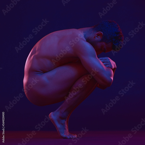 Nude, art and fetal with a model asian man in studio on a dark background for artistic body positivity. Skin, natural and freedom with a handsome young male posing naked on a black backdrop