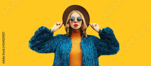 Obraz na plátně Fashionable portrait of stylish young woman, female model posing wearing blue fa