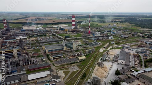 Aerial drone view of giant chemical plant, flying over chemistry pipes. A lot of pipes on a factory, industrial view with green background.