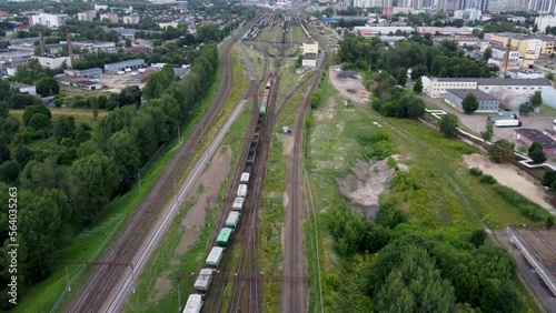 Trian approaching big sorting station, long trolley moving on it's own on a sunny day in Russia