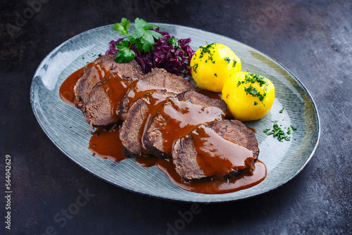 Obraz na plátně Traditional braised marinated German Sauerbraten from beef with blue kraut and p