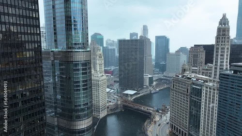 Aerial drone view flying in downtown Chicago loop over Chicago River on cold snowy winter day photo
