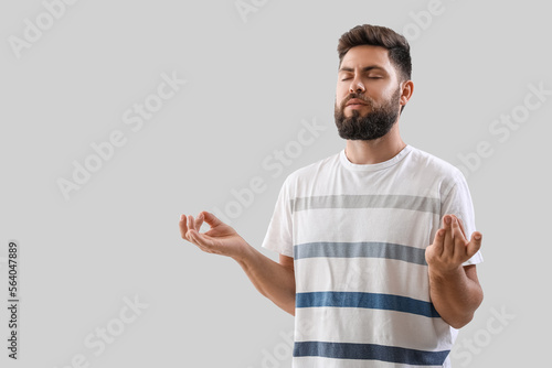 Handsome young man meditati...