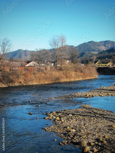 Beautiful mountain river in the village in autumn during sunset
