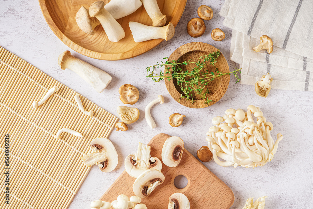 Fototapeta premium Composition with different fresh mushrooms on light background