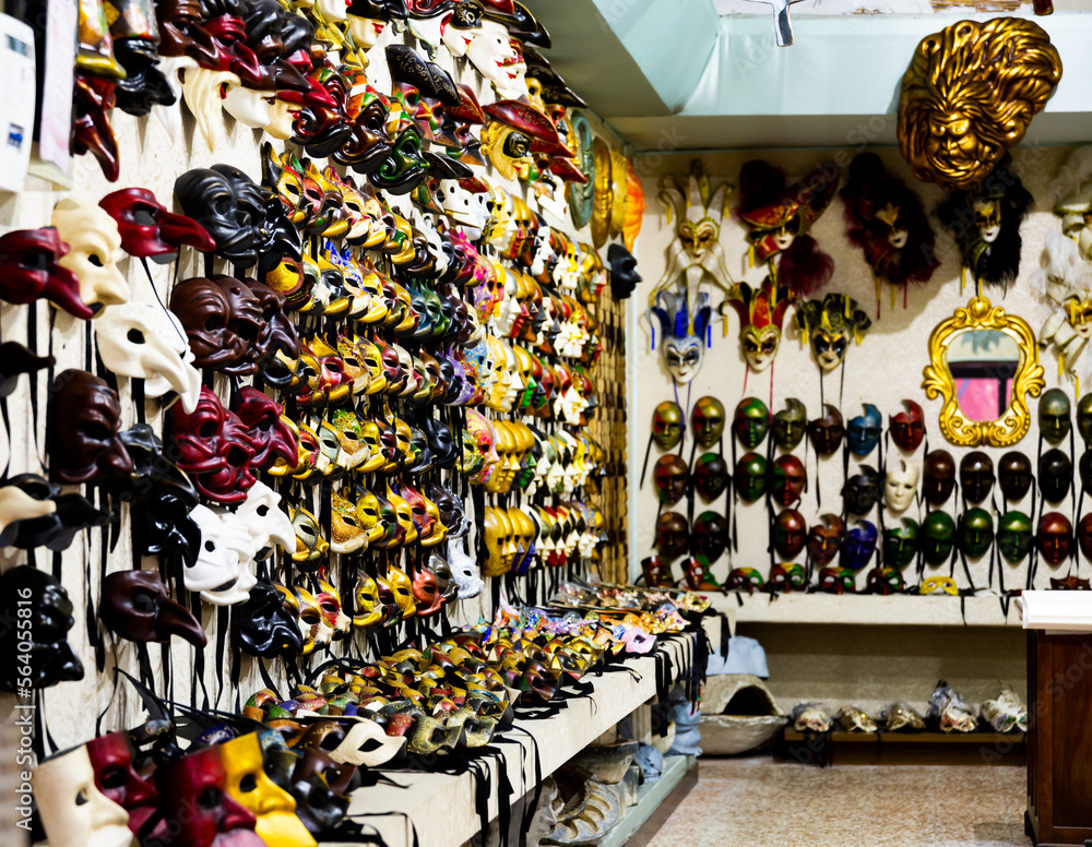 Traditional souvenir market in Venice offering large assortment of handmade colorful masks to remember your trip