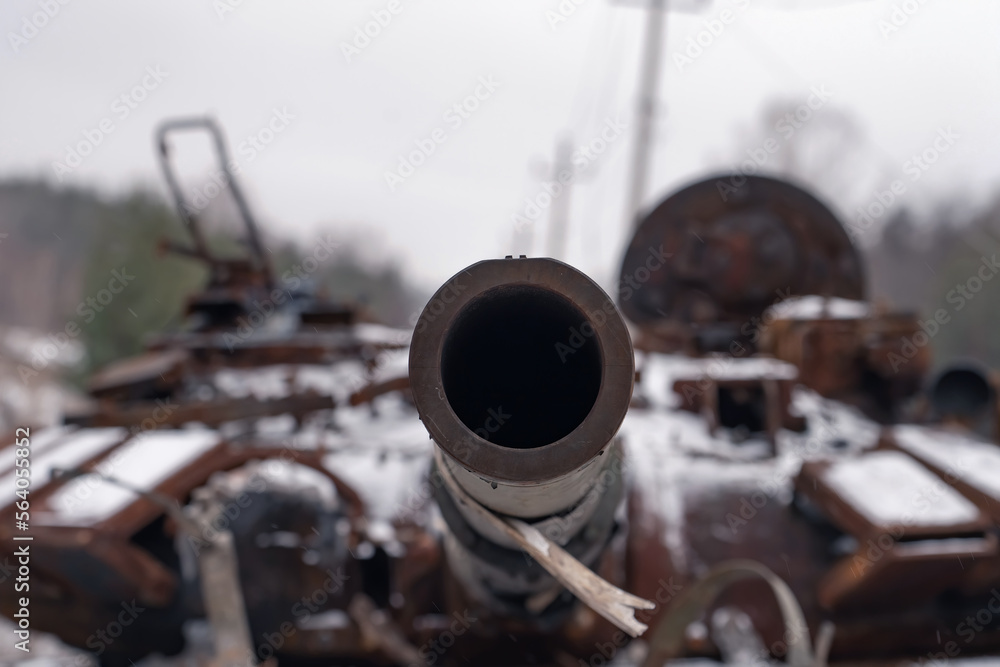 Destroyed tank. The muzzle is in focus. Remains of a combat vehicle at the scene of hostilities (concept of war) Destroyed tank. The muzzle is in focus. Remains of a combat vehicle at the scene of hostilities (concept of war)