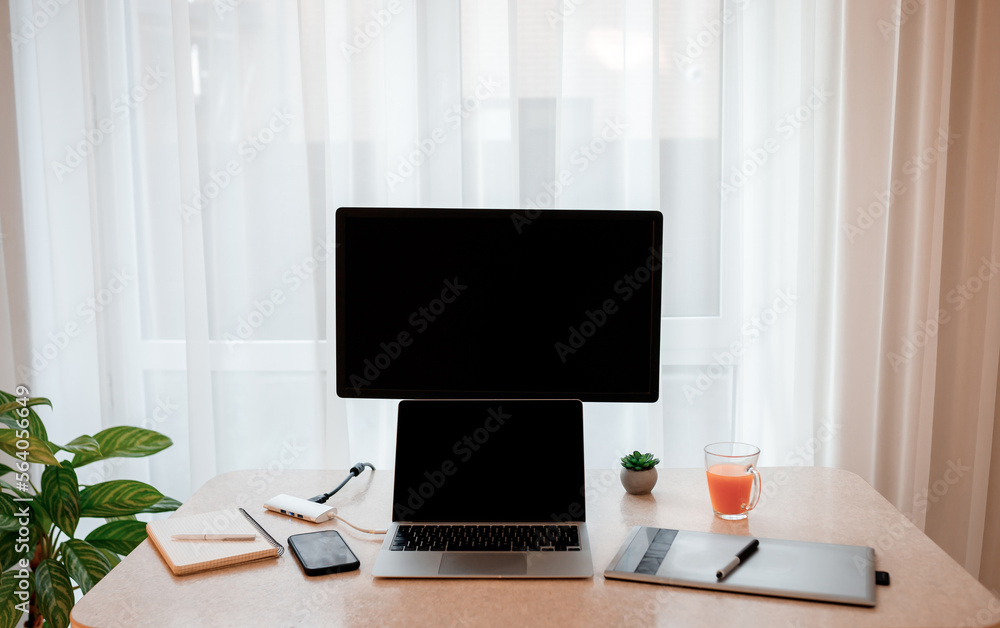 Workplace of graphic designer with computer , laptop, digital tablet and mobile phone