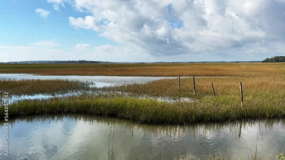 Beautiful view of an island salt marsh wetlands with partly cloudy skies Beautiful view of an island salt marsh wetlands with partly cloudy skies