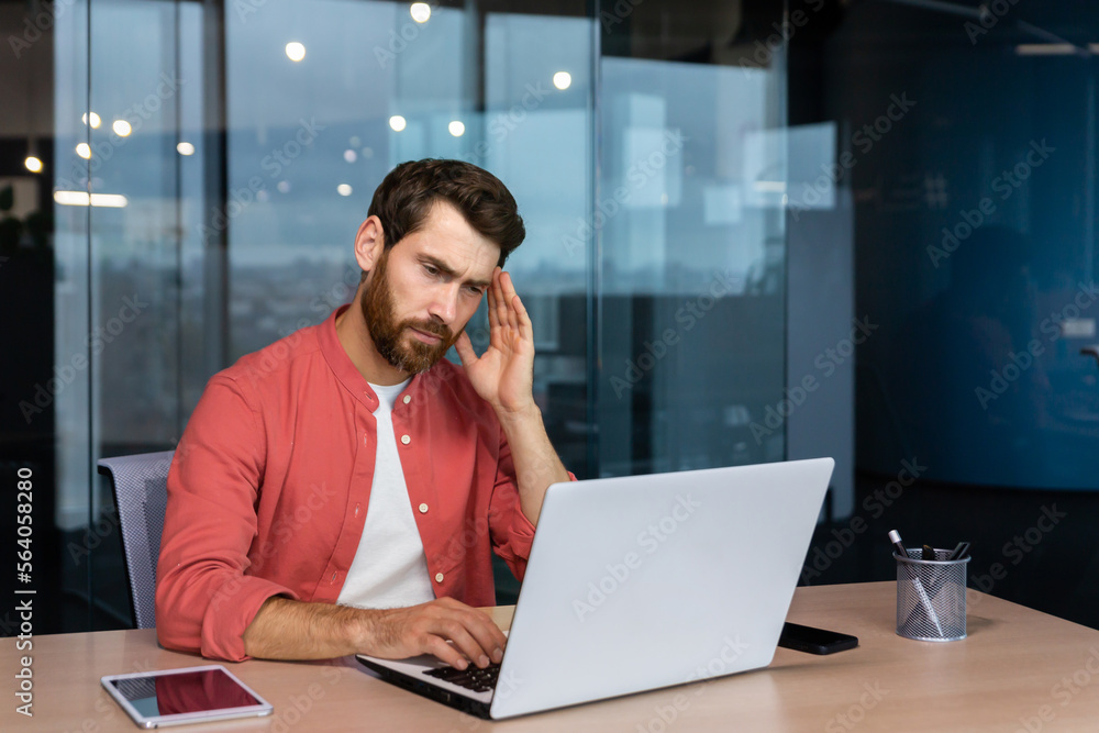 Sick man at workplace, mature businessman has severe headache, boss in shirt works inside office with laptop. Sick man at workplace, mature businessman has severe headache, boss in shirt works inside office with laptop.