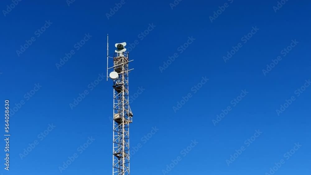 Coastal radar station against blue sky background. Radar tower on seashore Coastal radar station against blue sky background. Radar tower on seashore