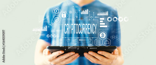 Vászonkép Cryptocurrency theme with man using a tablet