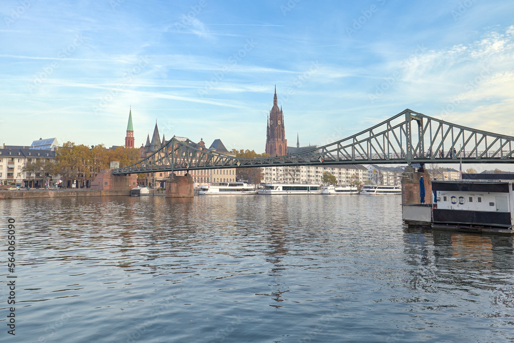 View of the dome of a cathedral over the iron bridge on the river Main, Frankfurt, Germany.