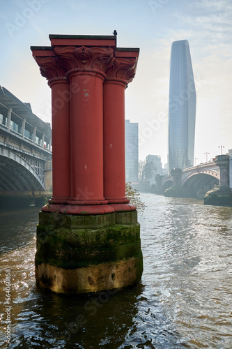 Canvas Print red pillars or columns from original Blackfriars railway bridge in river thames,