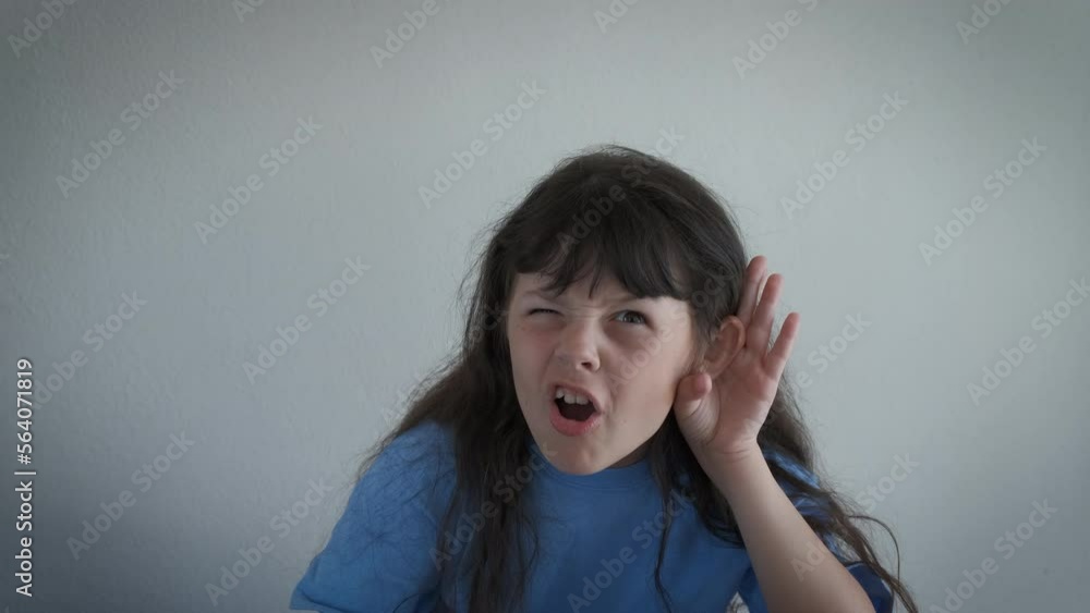 Child eavesdropping in the room. A cute little girl stay in the room and keep her hand by the ear to eavesdropping. Child eavesdropping in the room. A cute little girl stay in the room and keep her hand by the ear to eavesdropping.