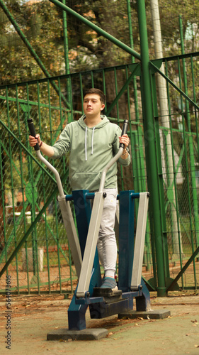 athlete doing cardio
young man exercising on machine
