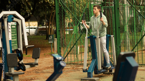 athlete doing cardio
young man exercising on machine

