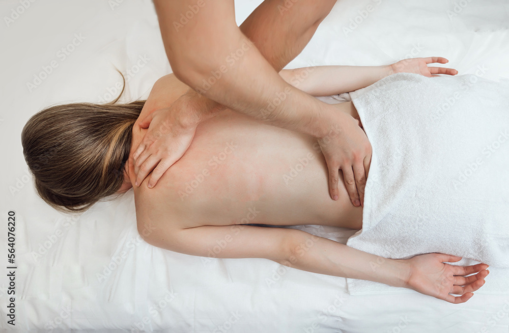 Professional masseur make remedial body massage to a Woman's body Professional masseur make remedial body massage to a Woman's body
