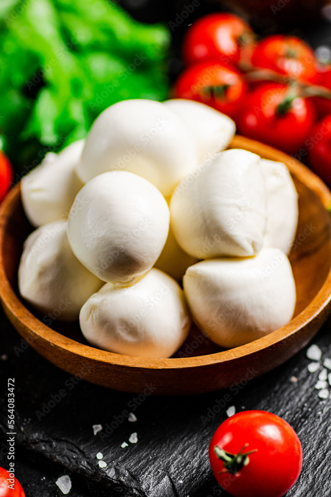 Mozzarella cheese with cherry tomatoes and lettuce. Mozzarella cheese with cherry tomatoes and lettuce.