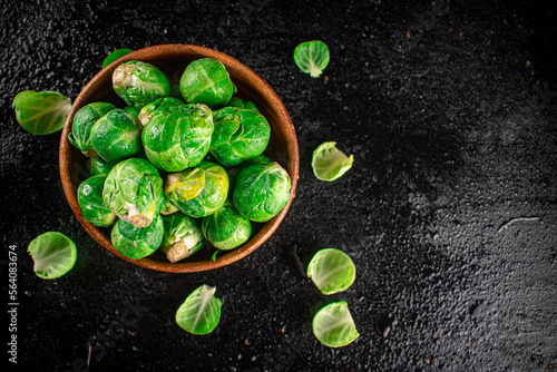 Brussels sprouts in a wooden bowl.  © Artem Shadrin