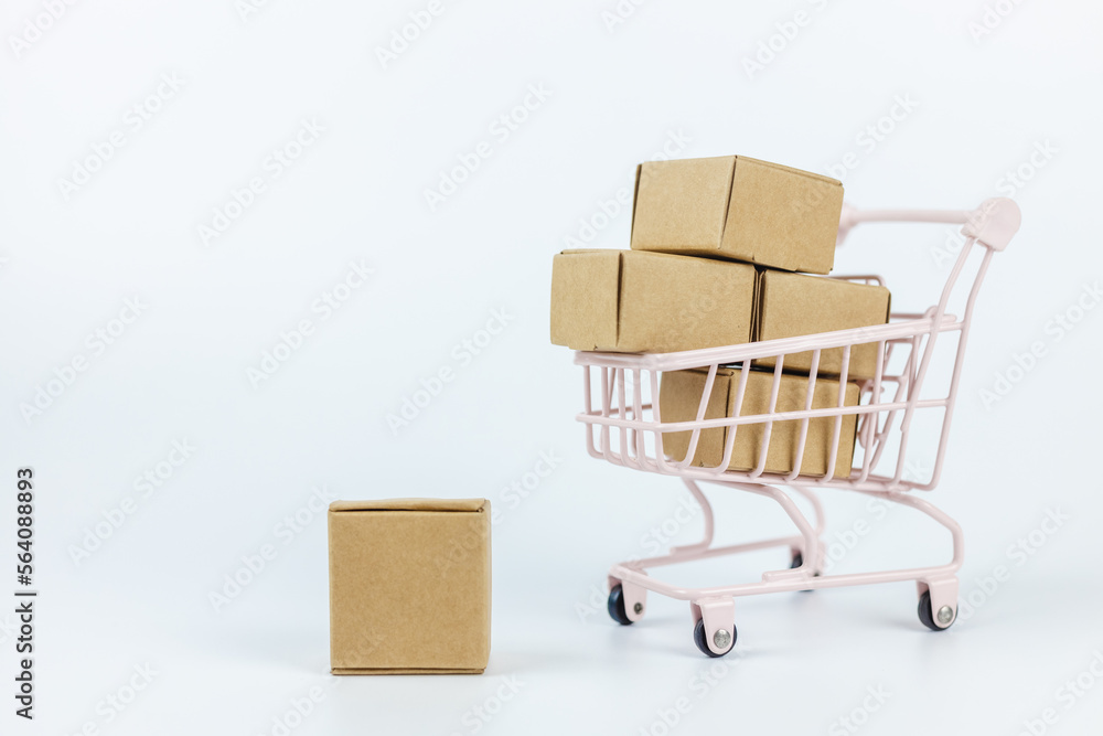 shopping online and logistic concept. paper box in small shopping cart white background. home delivery service from supermarket. import export, finance commerce. shopping online and logistic concept. paper box in small shopping cart white background. home delivery service from supermarket. import export, finance commerce.