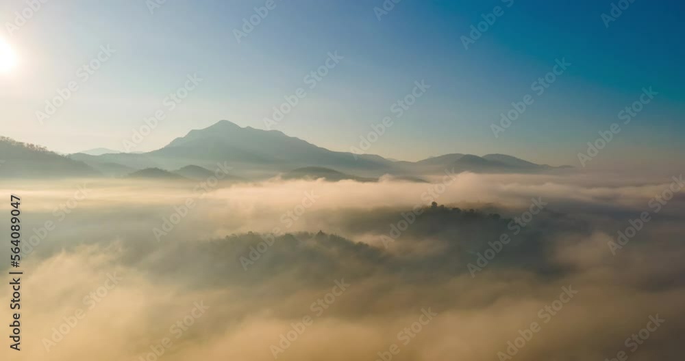 Amazing Sea mist around the mountains with Doi Luk San peak in the background with sunrise at Mae Hong Son province unseen Thailand.Aerial view Motion Time lapse with dolly in and panning drone camera Amazing Sea mist around the mountains with Doi Luk San peak in the background with sunrise at Mae Hong Son province unseen Thailand.Aerial view Motion Time lapse with dolly in and panning drone camera