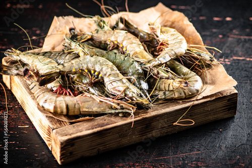 Raw shrimp on a wooden tray. 