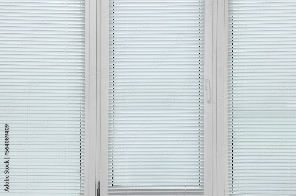 Stylish window with horizontal blinds in room