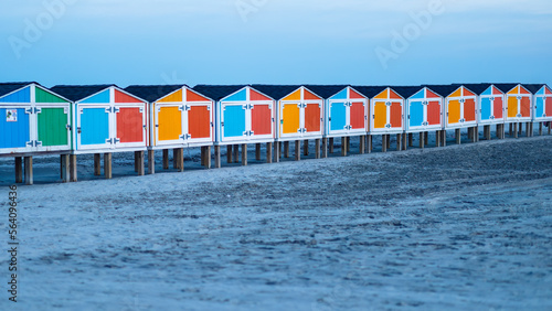 Wildwood New Jersey NJ ocean at night with colorful beach storage on sand landscape perspective photo