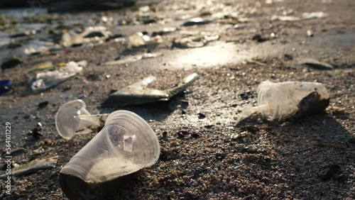Wallpaper Mural Throw away lots of drinking glasses and trash on the beach, plastic cups, and plastic bags. Marine debris is one of the world's major environmental problems. Conserving the environment  Torontodigital.ca