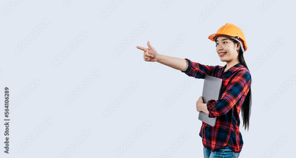 Young female engineer wearing Yellow helmet and use laptop computer Young female engineer wearing Yellow helmet and use laptop computer