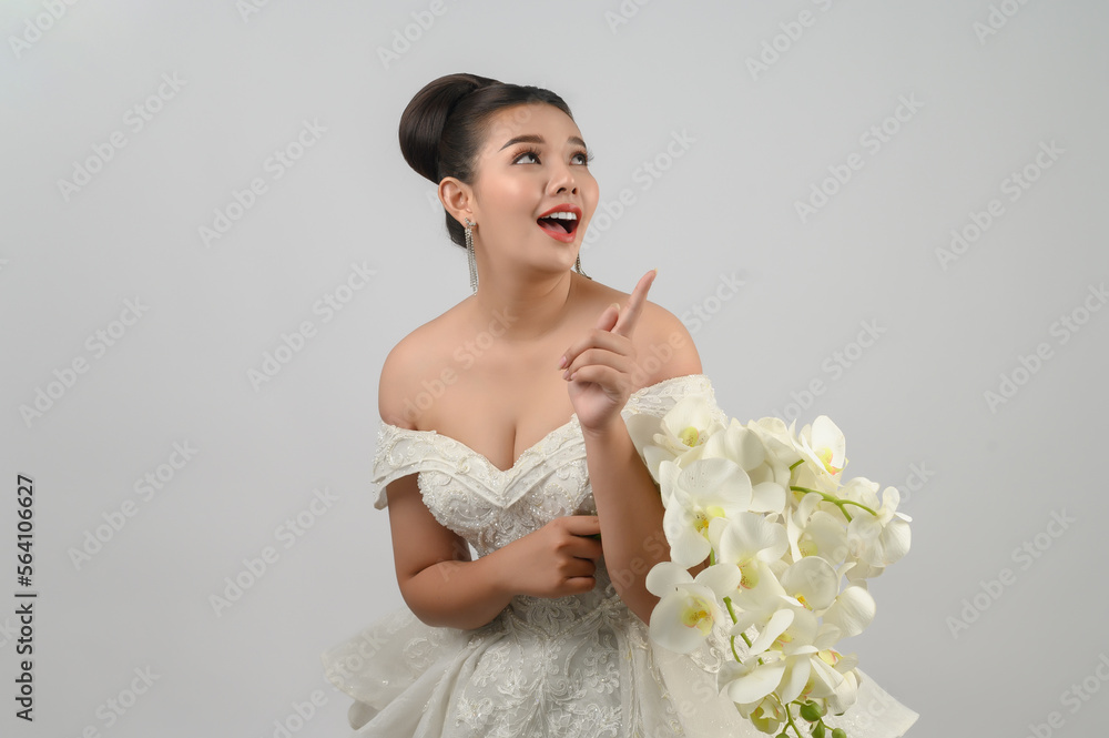 Young asian beautiful bride point finger with happy on white background