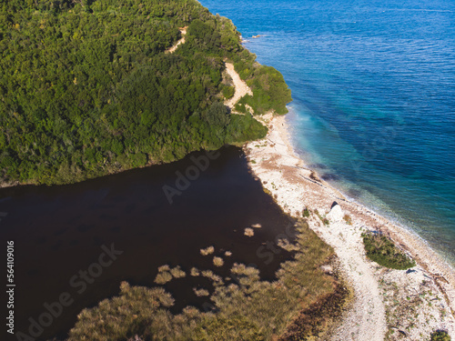 View of Erimitis coast landscape near Kassiopi and Agios Stefanos village, Corfu island, Kerkyra, Greece, with hiking trail path, forest and beach in a summer sunny day