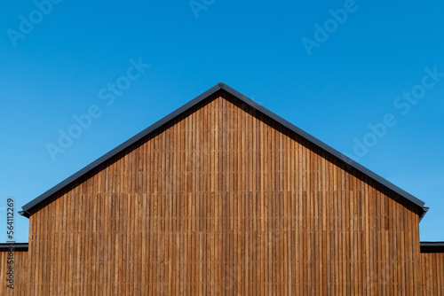 Facade decoration of the roof gable with natural wood plank of a new modern house, copy space.