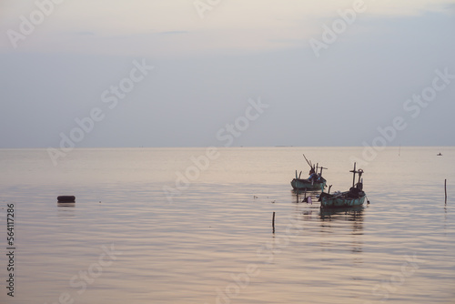 fishing boats sailing in the middle of the sea