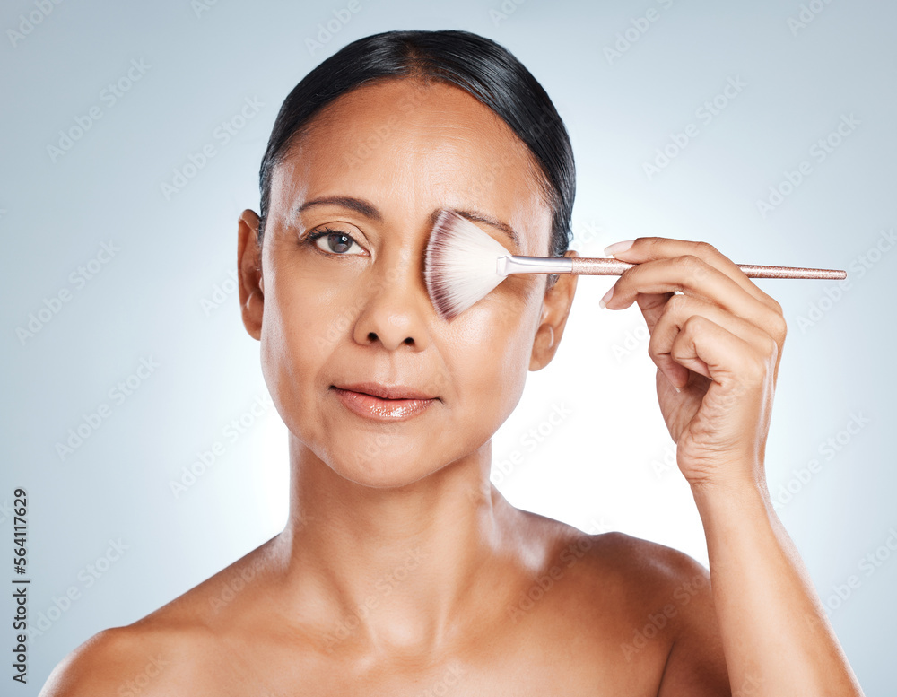 Makeup brush, hand and mature woman portrait for skincare, cosmetic luxury and wellness. Blue background, studio and isolated model with cosmetics tools and microblading aesthetic for self care Makeup brush, hand and mature woman portrait for skincare, cosmetic luxury and wellness. Blue background, studio and isolated model with cosmetics tools and microblading aesthetic for self care